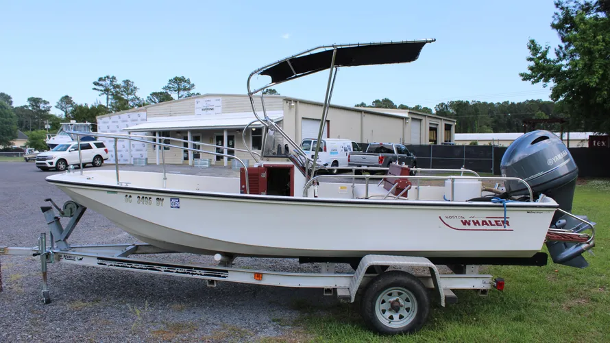 1982 Boston Whaler 17 Montauk center console boat on trailer, featuring Yamaha F90 outboard engine, showcasing its classic design and ready for sale at Cape Romain Marine.