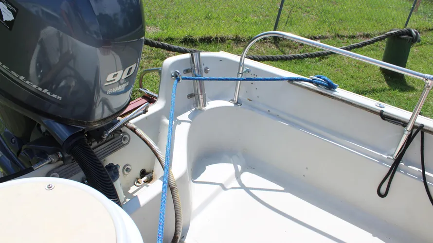 Yamaha 90hp outboard motor on a 1982 Boston Whaler 17 Montauk, showcasing the boat's center console and interior details, highlighting its readiness for sale.