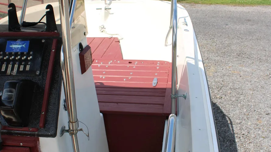Interior view of a 1982 Boston Whaler 17 Montauk showing control panel, seating area, and deck space, highlighting its classic center console design and readiness for use.