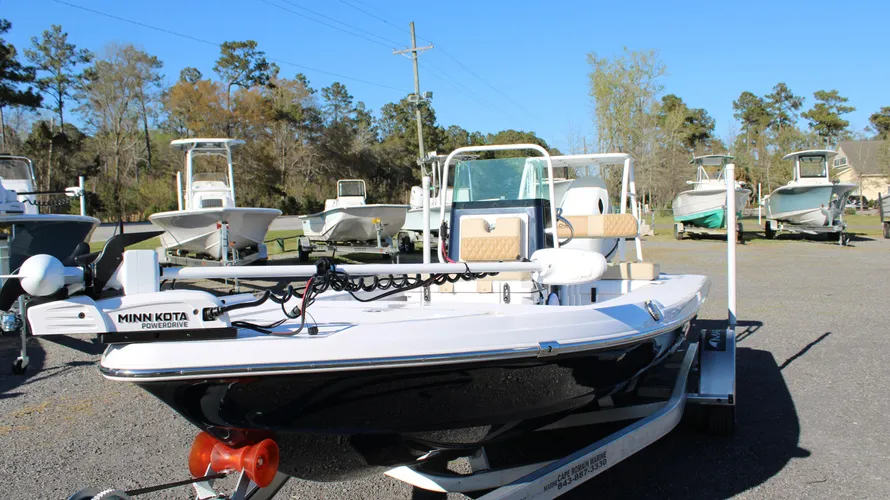 2025 Action Craft 17 Flyfisher boat in blue with Minn Kota PowerDrive, showcased at Cape Romain Marine dealership, surrounded by other boats in a sunny outdoor setting.