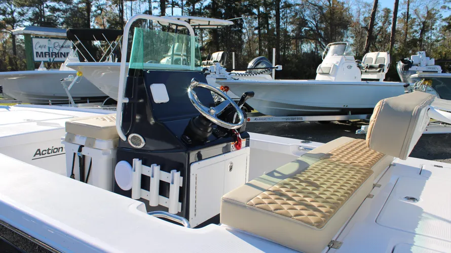 Action Craft 17 Flyfisher boat interior showcasing steering console, cushioned seating, and marine setting at Cape Romain Marine dealership.