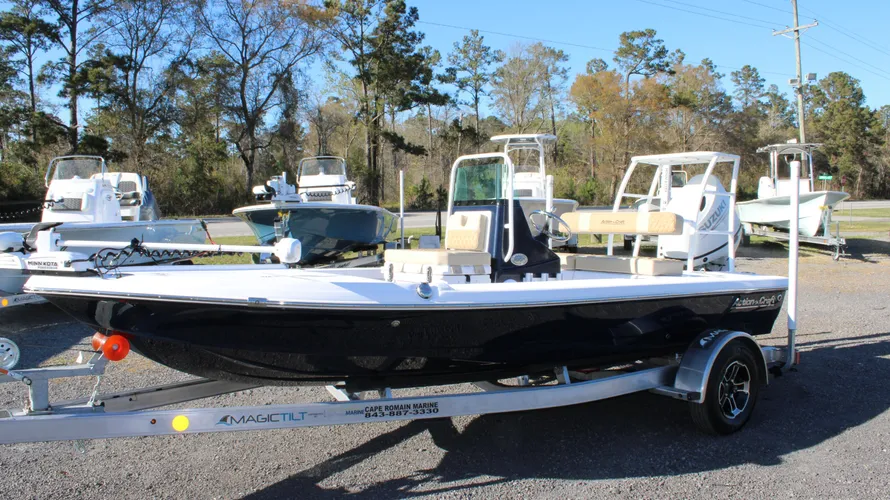 2025 Action Craft 17 Flyfisher boat in blue, displayed on a trailer at Cape Romain Marine, showcasing its sleek design and features among other boats in the background.