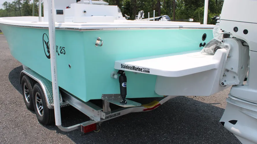 2025 C-Hawk 25 Center Console boat in turquoise color, showcasing rear view with Suzuki DF300APXW5 engine, mounted on a trailer, emphasizing its design for saltwater fishing and capacity for 8 people.