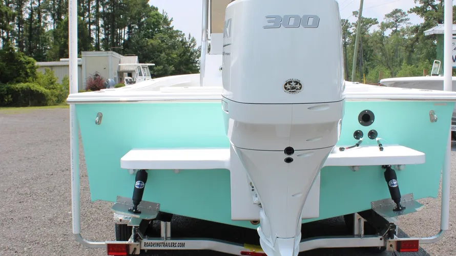 2025 C-Hawk 25 Center Console boat rear view showcasing Suzuki 300hp outboard motor, mint green hull, and fishing features.