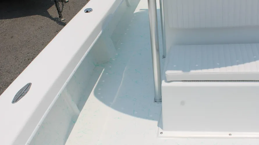 Interior view of the 2025 C-Hawk 25 Center Console boat featuring a clean, white deck surface, seating area, and stainless steel fittings, emphasizing its suitability for saltwater fishing and recreational use.