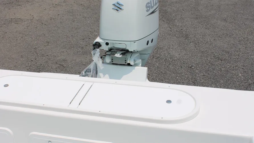 Suzuki DF300APXW5 outboard motor on a 2025 C-Hawk 25 Center Console boat, showcasing the engine and mounting area.