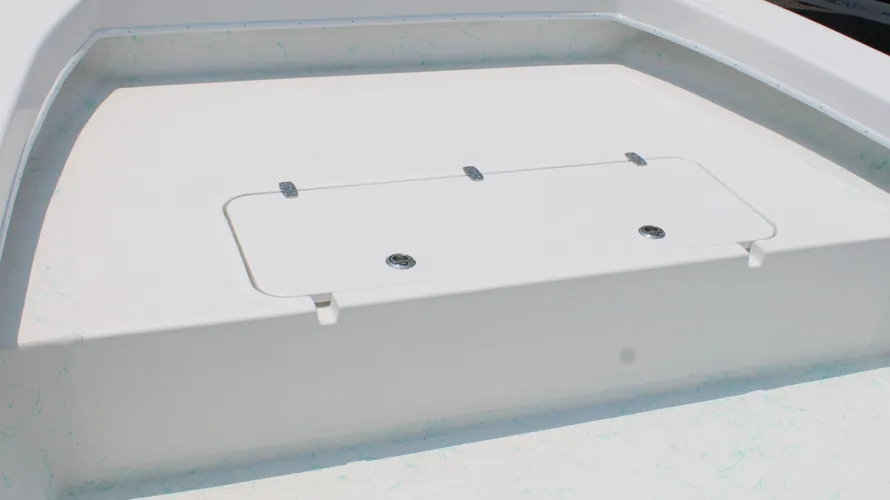 Boat deck featuring a clean, white surface with a hatch and two flush-mounted fittings, showcasing the design of the 2025 C-Hawk 25 Center Console, ideal for saltwater fishing.
