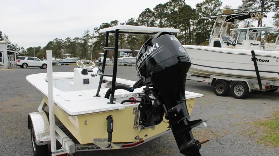2025 Mitzi Skiff 17 Tournament in Fighting Lady Yellow with a Suzuki 60hp outboard motor, showcasing a spacious deck and steering console, parked at Cape Romain Marine dealership.