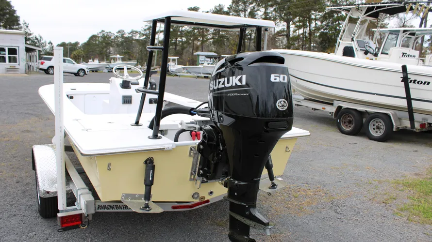 2025 Mitzi Skiff 17 Tournament in Fighting Lady Yellow with a 60hp Suzuki outboard motor, showcasing a sleek design and spacious deck, parked at Cape Romain Marine.