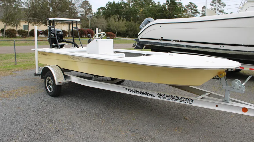 2025 Mitzi Skiff 17 Tournament in Fighting Lady Yellow, showcasing a sleek design on a trailer, with Suzuki outboard motor, parked at Cape Romain Marine.