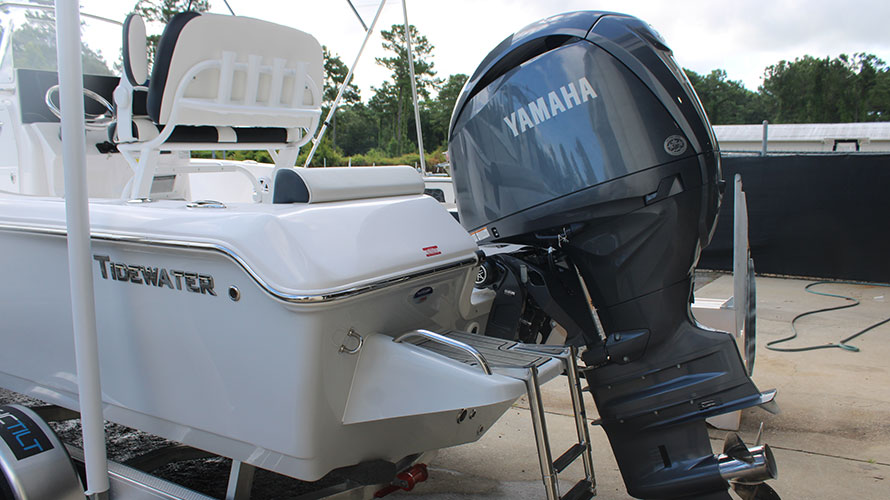 Tidewater 198CC boat with Yamaha 150HP outboard engine, showcasing fiberglass hull and sleek design, in a marine setting.