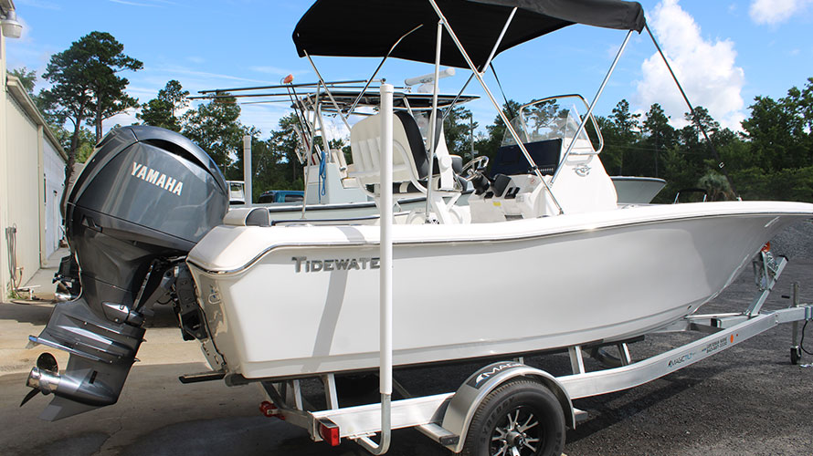 2025 Tidewater Boats 198CC with Yamaha 150HP outboard motor, fiberglass hull, and trailer, showcasing Whisper Grey color in a marine setting.