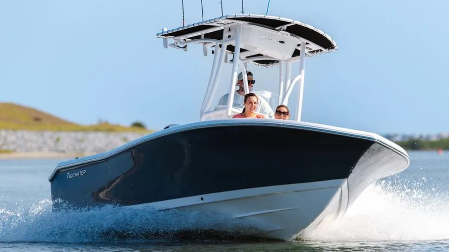 2025 Tidewater Boats 198CC cruising on water with passengers, showcasing sleek design and performance features.