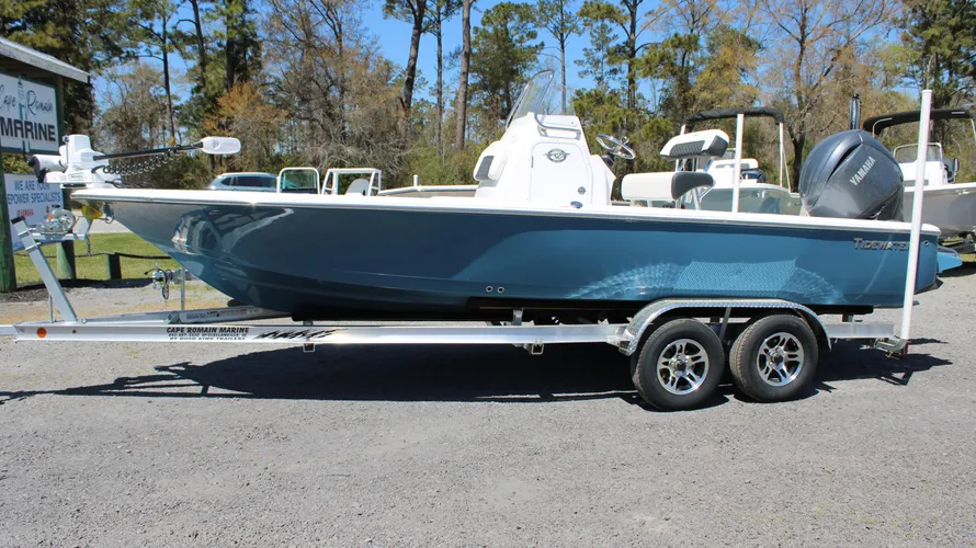 2025 Tidewater Boats 2110 Bay Max in Blue Mist color, displayed on a trailer at Cape Romain Marine, featuring a Yamaha outboard engine and surrounded by trees in a dealership setting.