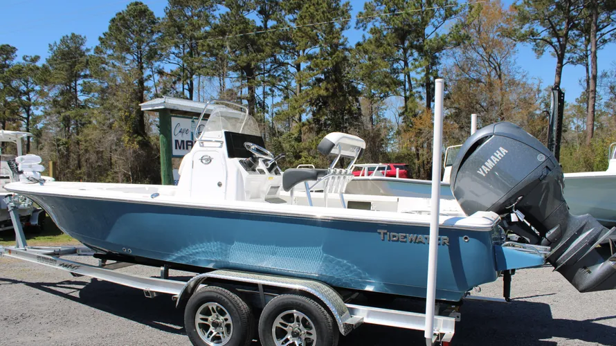 2025 Tidewater Boats 2110 Bay Max in Blue Mist, featuring Yamaha outboard engine, displayed on a trailer at Cape Romain Marine, surrounded by trees.