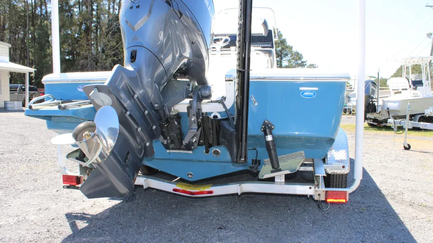 2025 Tidewater Boats 2110 Bay Max with Yamaha F150XC outboard engine, showcasing blue mist hull and trailer, set in a marine dealership environment.