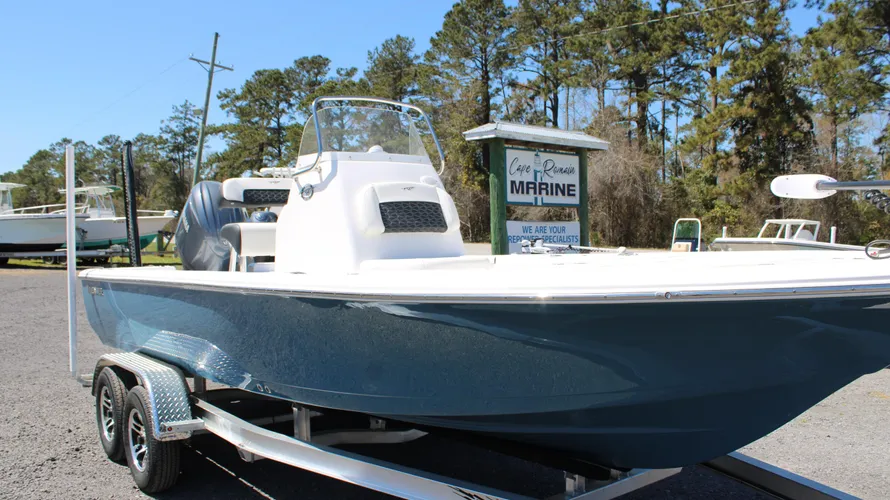 2025 Tidewater Boats 2110 Bay Max in Blue Mist color, displayed on a trailer at Cape Romain Marine, showcasing its sleek fiberglass hull and Yamaha outboard engine.