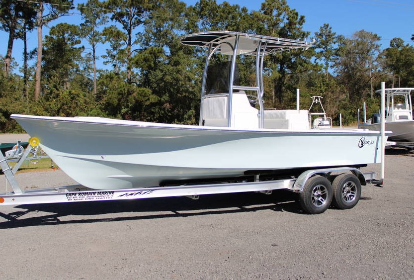 2025 C-Hawk 23CC center console boat in Seamist color, showcasing a sleek design, trailer, and surrounding marine environment, available at Cape Romain Marine.