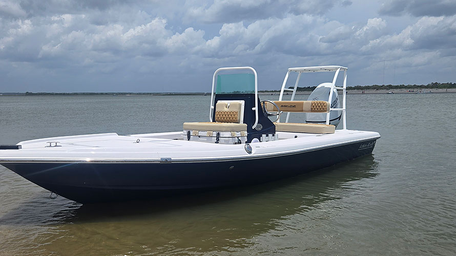 2025 Action Craft 17 Flyfisher boat in blue, featuring dual seating, a Suzuki outboard engine, and a spacious deck, showcased in a water setting with cloudy skies.