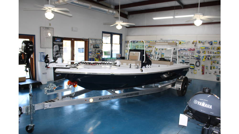 2025 Action Craft 17 Flyfisher boat displayed in showroom with Suzuki outboard engine, showcasing sleek blue and white design, surrounded by marine accessories.