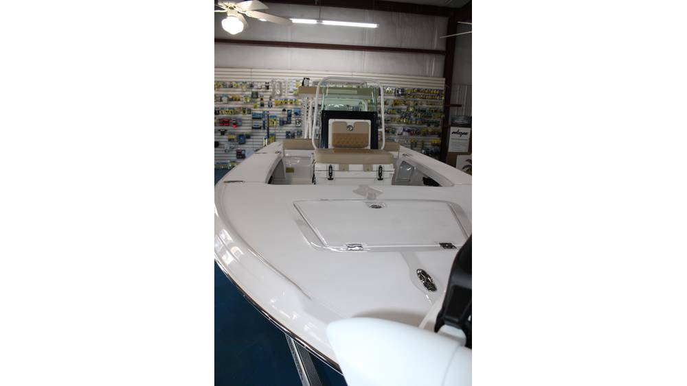2025 Action Craft 17 Flyfisher boat interior view showcasing seating and storage features in a marine dealership setting.