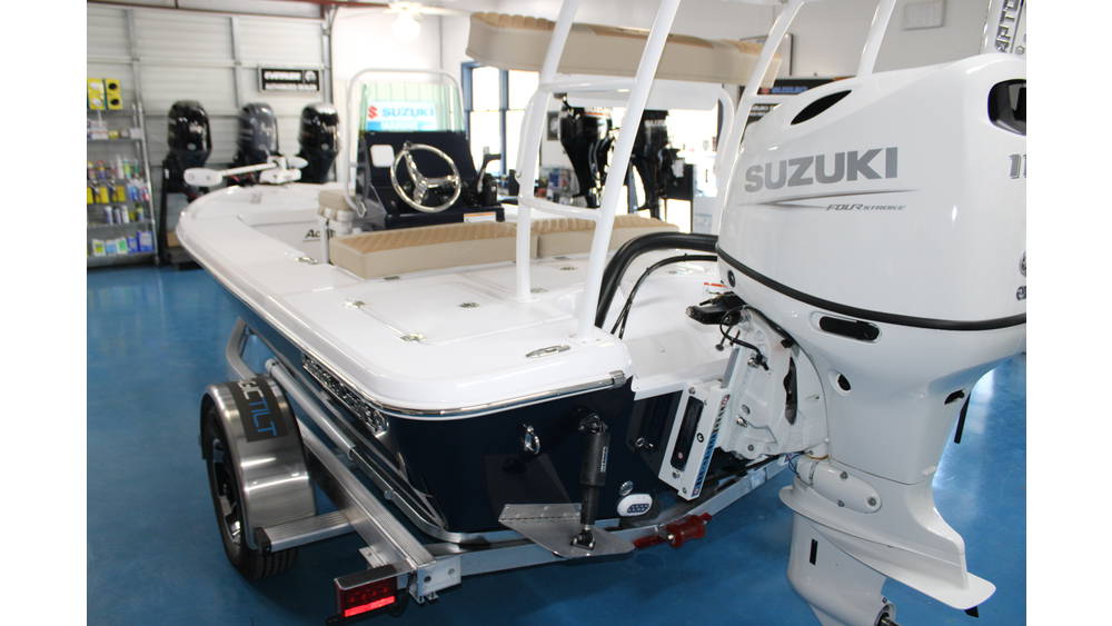 2025 Action Craft 17 Flyfisher boat with Suzuki DF115 outboard engine, displayed in a marine showroom, featuring a blue color scheme and modern design elements.