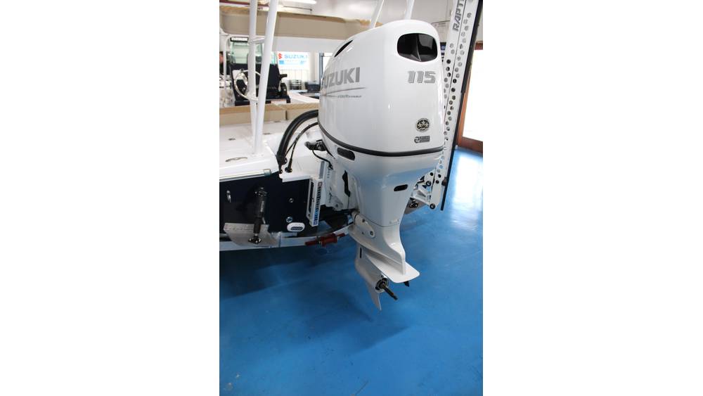 Suzuki DF115 outboard engine displayed in a marine showroom, showcasing features relevant to the 2025 Action Craft 17 Flyfisher model.