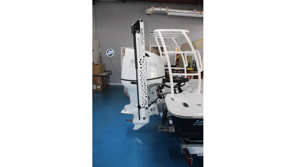 2025 Action Craft 17 Flyfisher boat with Suzuki outboard motor displayed in showroom, highlighting engine details and boat features.
