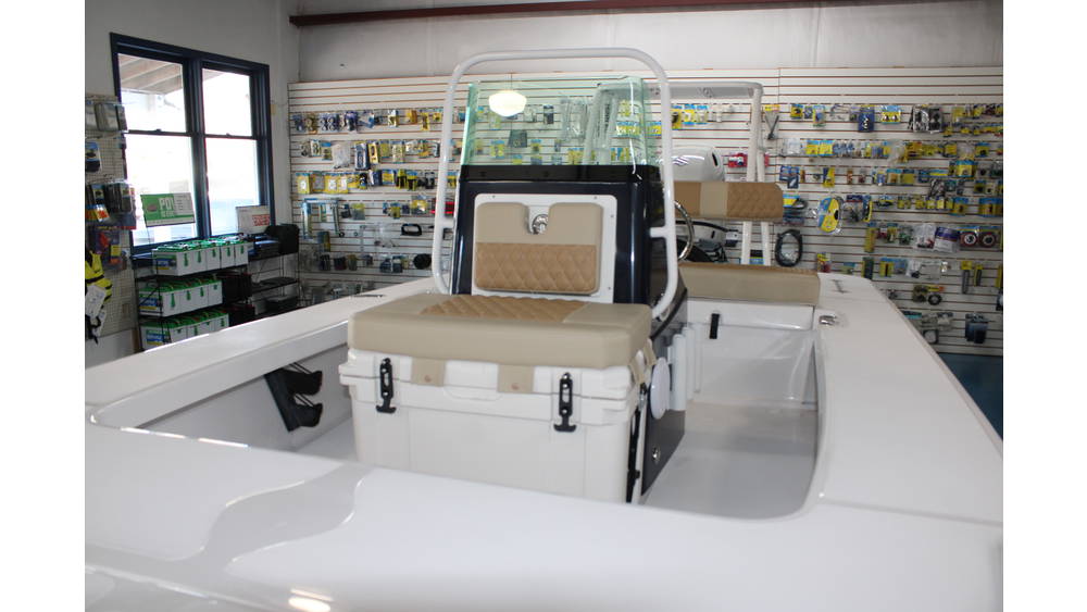 2025 Action Craft 17 Flyfisher interior view showcasing seating, storage, and helm in a marine dealership setting.
