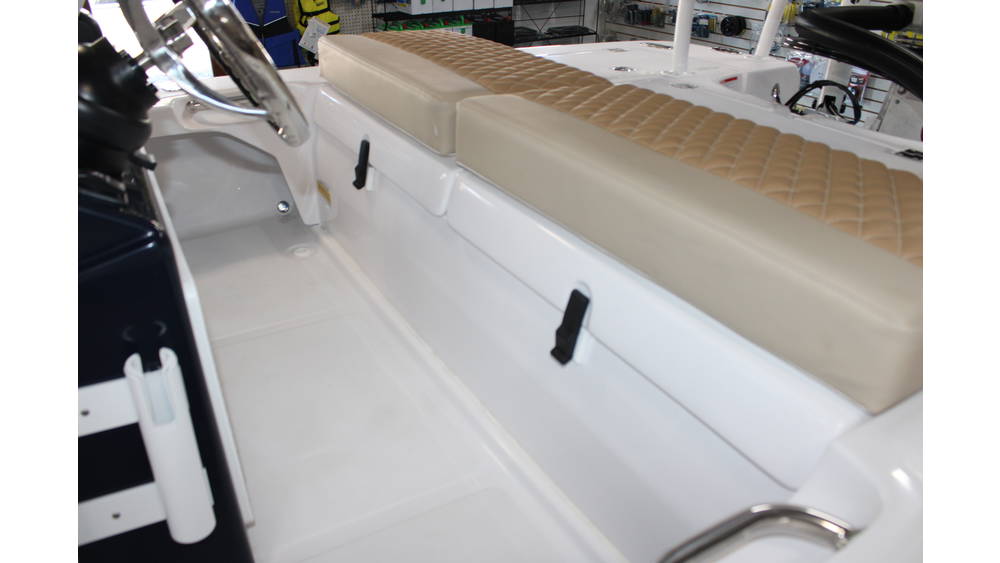 Interior view of the 2025 Action Craft 17 Flyfisher, featuring a beige cushioned bench seat, steering wheel, and clean white flooring, showcasing the boat's design and layout for potential buyers.