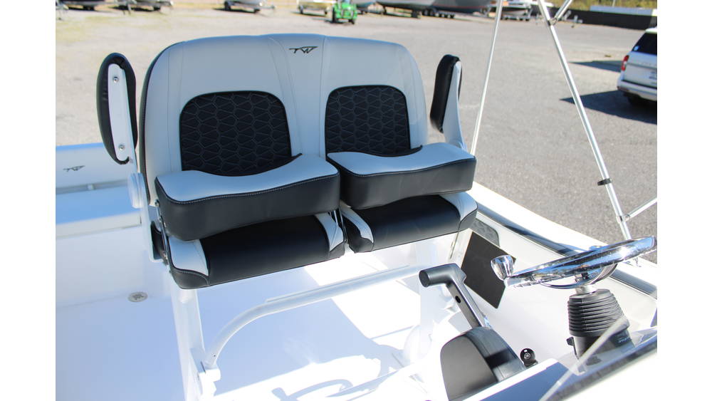 Dual cushioned boat seats in grey and black upholstery, featuring a steering wheel and control panel, showcasing the interior design of the 2025 Tidewater Boats 198CC.