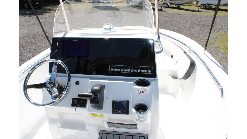 Boat dashboard of the 2025 Tidewater Boats 198CC featuring steering wheel, control panel, and electronic display, showcasing modern marine instrumentation and design elements.
