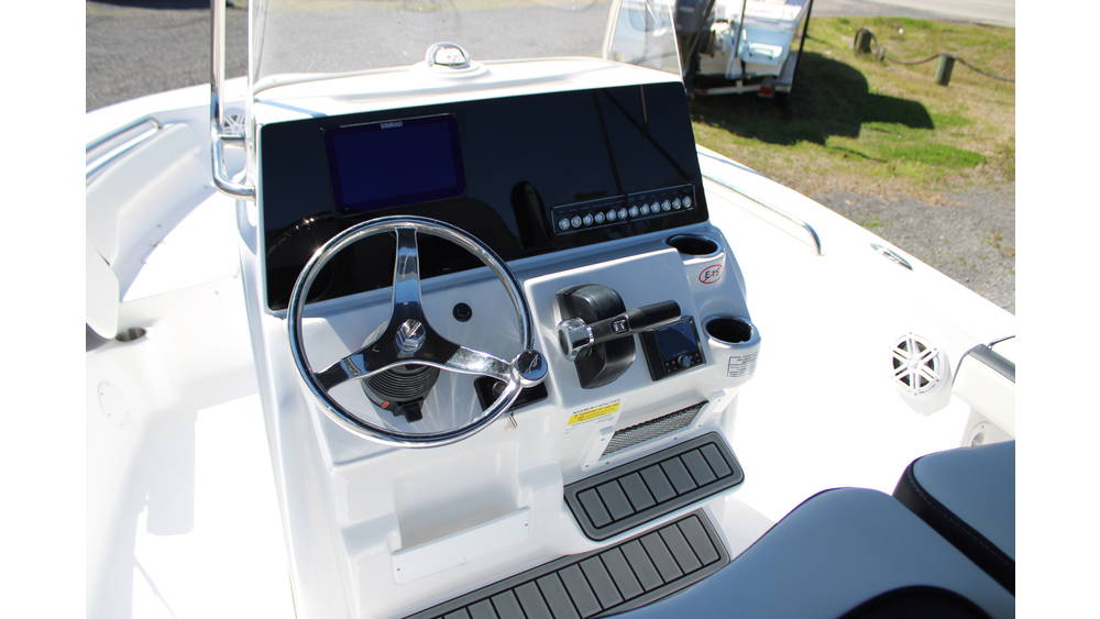 Tidewater Boats 198CC console featuring a steering wheel, digital display, and control panel, showcasing modern marine navigation and control features.