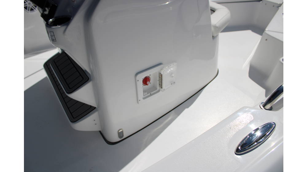 Detail of the 2025 Tidewater Boats 198CC's engine compartment, showcasing the Yamaha outboard motor, control panel, and sleek white fiberglass interior.