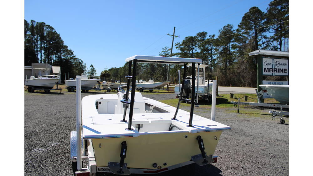 2025 17 Tournament Mitzi Skiff in Fighting Lady Yellow at Cape Romain Marine, showcasing rear view with dual live wells and other boats in background.