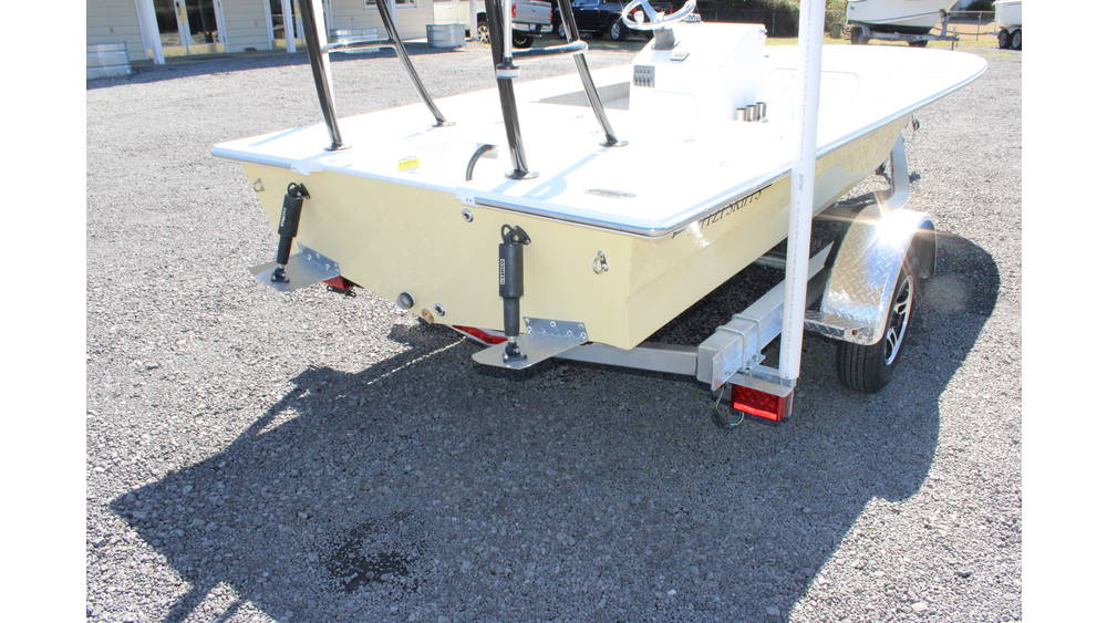 New 2025 17 Tournament Mitzi Skiff in Fighting Lady Yellow, showcasing rear view with trailer, equipped with Suzuki outboard motor, parked on gravel lot at Cape Romain Marine.