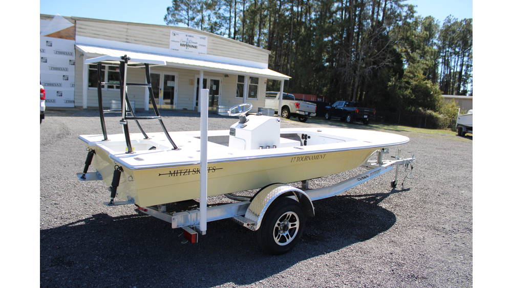 2025 17 Tournament Mitzi Skiff in Fighting Lady Yellow, showcasing a sleek design, equipped with a 60hp Suzuki engine, parked on a trailer outside Cape Romain Marine dealership.