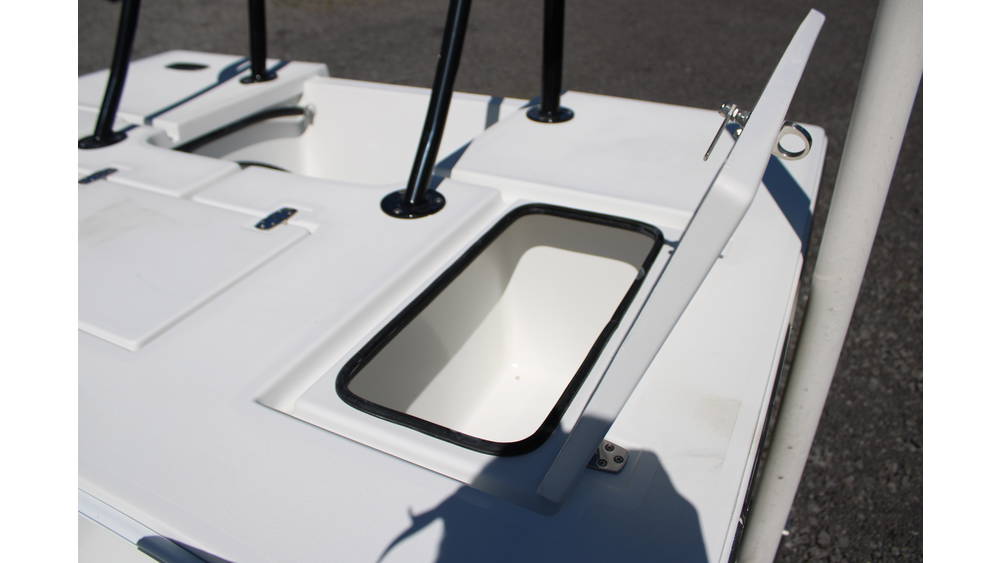 Interior view of a Mitzi Skiff featuring a live well compartment, showcasing white surfaces and black trim, emphasizing the boat's design and functionality.