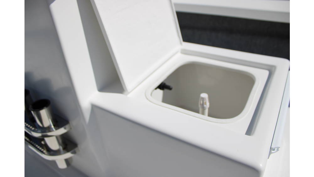 Live well compartment on a 2025 17 Tournament Mitzi Skiff, featuring a white lid and interior, showcasing boat's fishing amenities.