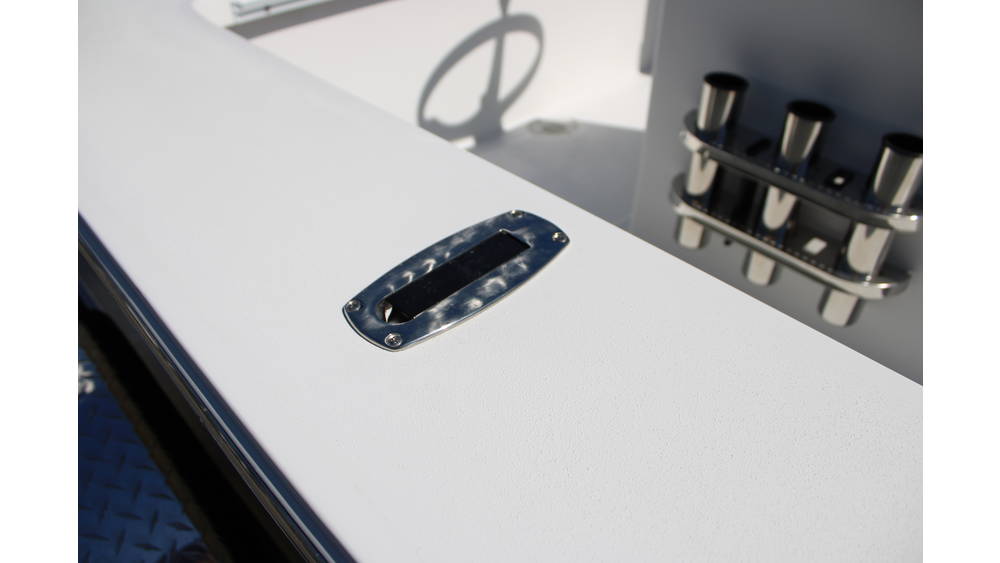 Detail of a white boat surface featuring a stainless steel cleat and rod holders, highlighting the craftsmanship of the 2025 17 Tournament Mitzi Skiff at Cape Romain Marine.