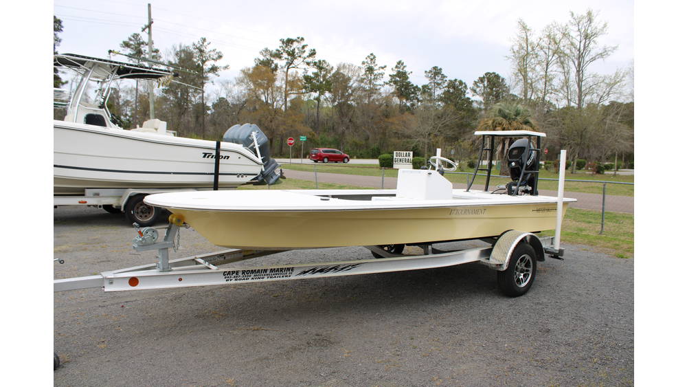 2025 17 Tournament Mitzi Skiff in Fighting Lady Yellow, showcasing sleek design and Suzuki outboard motor, parked at Cape Romain Marine dealership with surrounding greenery.