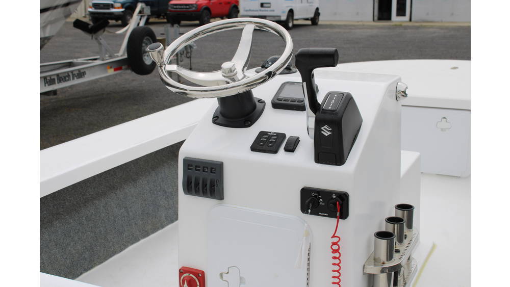 Boat control console featuring steering wheel, throttle, and Suzuki outboard controls, showcasing the 2025 17 Tournament Mitzi Skiff's design and functionality.