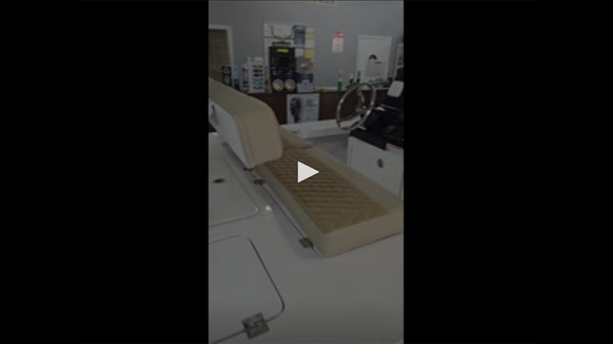 Interior view of the 2025 Action Craft 17 Flyfisher showcasing plush seating and control panel, emphasizing comfort and functionality for fishing enthusiasts.