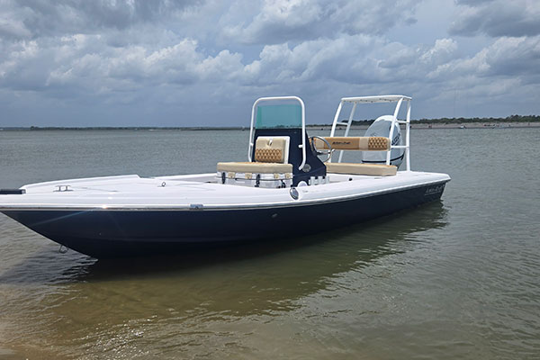 2025 Action Craft 17 Flyfisher flats boat in water, featuring a spacious layout, dual seating, and a sleek design, ideal for saltwater fishing.